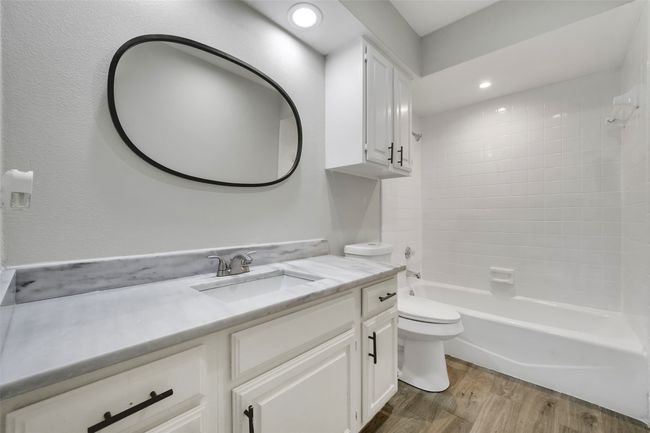Full bathroom with vanity, wood finished floors, tub / shower combination, and recessed lighting | Image 20
