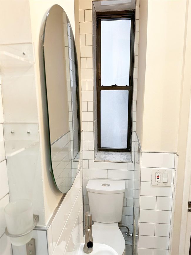 Bathroom with toilet and tile walls | Image 20