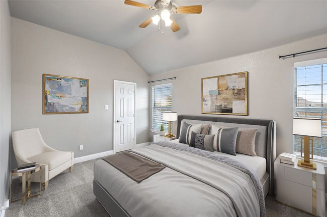 Carpeted bedroom featuring lofted ceiling, baseboards, and a ceiling fan | Image 8