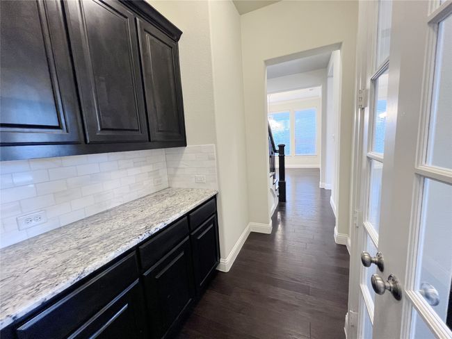 Corridor with dark wood-style floors and baseboards | Image 10