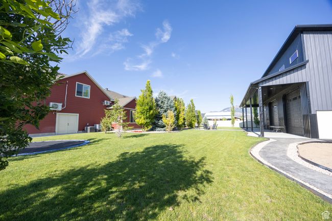 View of grassy yard featuring a garage | Image 68