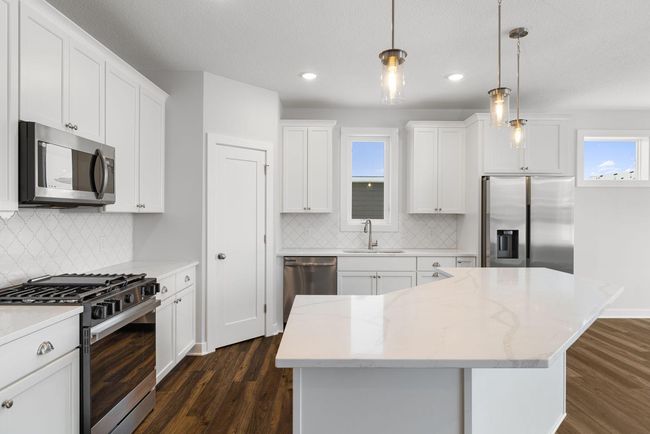 At the heart of the kitchen, a stunning center island serves as a focal point, offering ample workspace and seating—perfect for meal prep, casual dining, or entertaining. | Image 16
