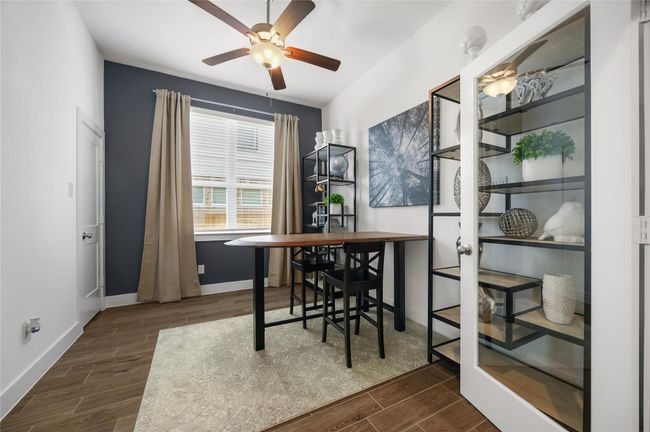 Behind stylish French doors, this versatile study is perfect for a home office, library, or creative retreat. A ceiling fan and large window offer both comfort and inspiration. | Image 5