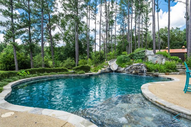 View of pool with a water slide | Image 34