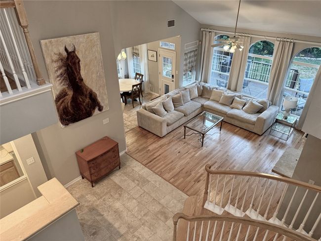 Living room featuring visible vents, a ceiling fan, baseboards, and high vaulted ceiling | Image 19