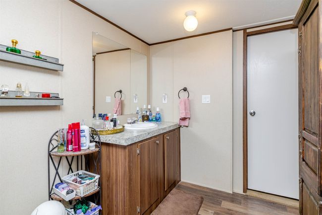 Bathroom with vanity, ornamental molding, and wood finished floors | Image 21