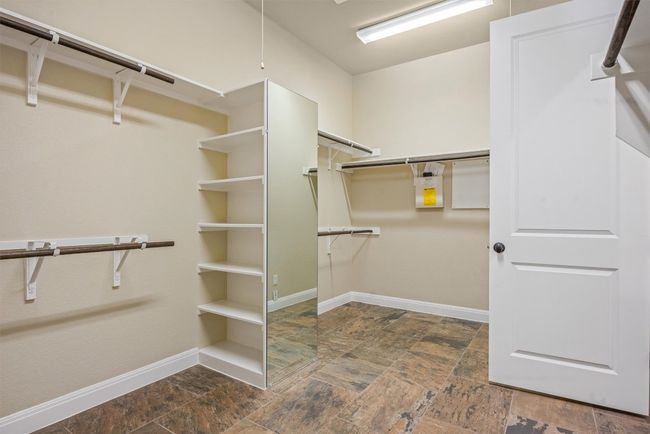 Walk in closet with dark stone finish flooring | Image 31