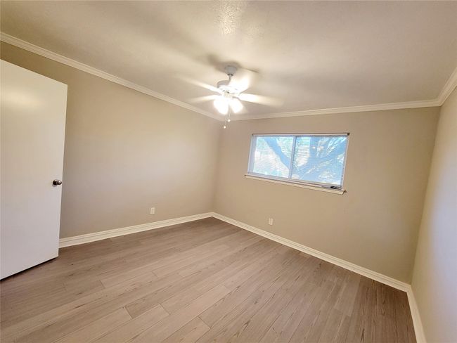 Unfurnished room featuring ceiling fan, ornamental molding, and light wood-type flooring | Image 18
