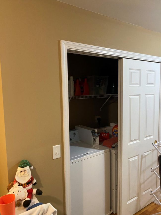 Laundry area featuring washing machine and clothes dryer and laundry area | Image 13