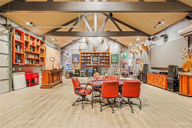 30x40ft game room /entertainment room with an AC wall unit and wood finished floors | Image 41