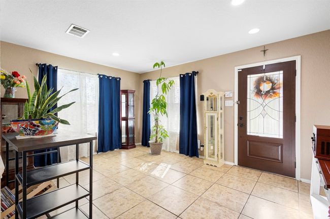 Entrance foyer with light tile patterned flooring, visible vents, recessed lighting, and a healthy amount of sunlight | Image 16