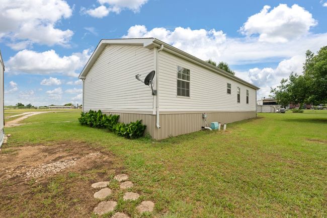 View of property exterior featuring a lawn | Image 27