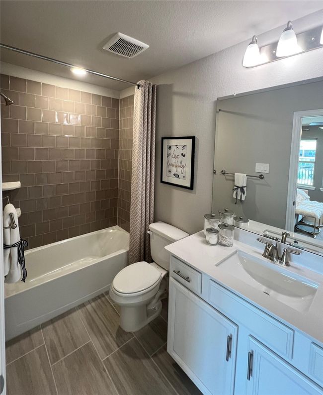Bathroom with shower / bathtub combination with curtain and vanity | Image 22