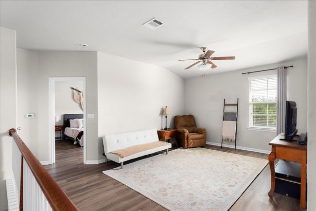Sitting room featuring wood finished floors, a ceiling fan, and baseboards | Image 11