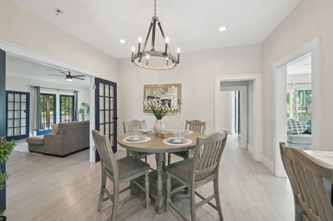 Dining area with light wood-type flooring, a chandelier, recessed lighting, baseboards, and french doors | Image 10