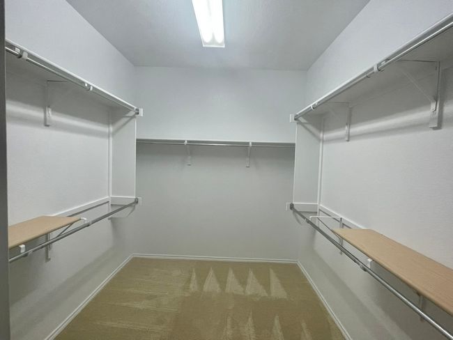 Spacious closet with carpet flooring | Image 15