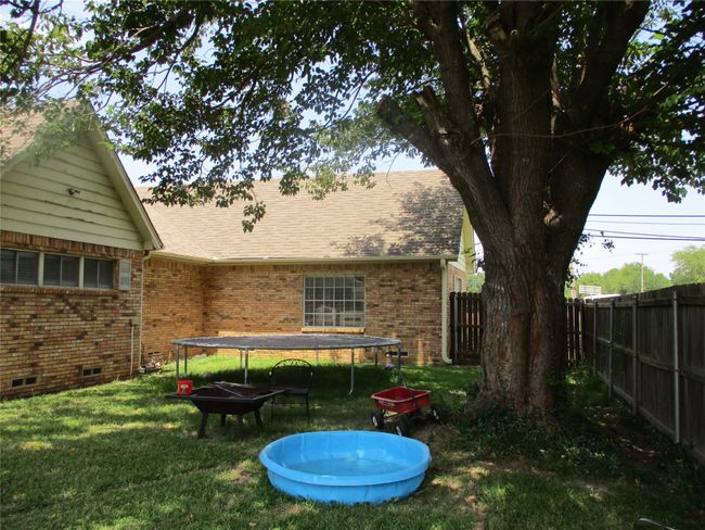 View of yard featuring a trampoline | Image 9