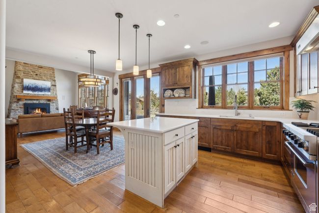 Kitchen featuring high end stove, a sink, plenty of natural light, and light countertops | Image 12