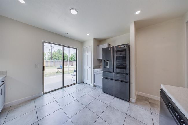 Pantry with plenty of room offers organized storage for groceries and kitchen supplies. The refrigerator is included! | Image 16