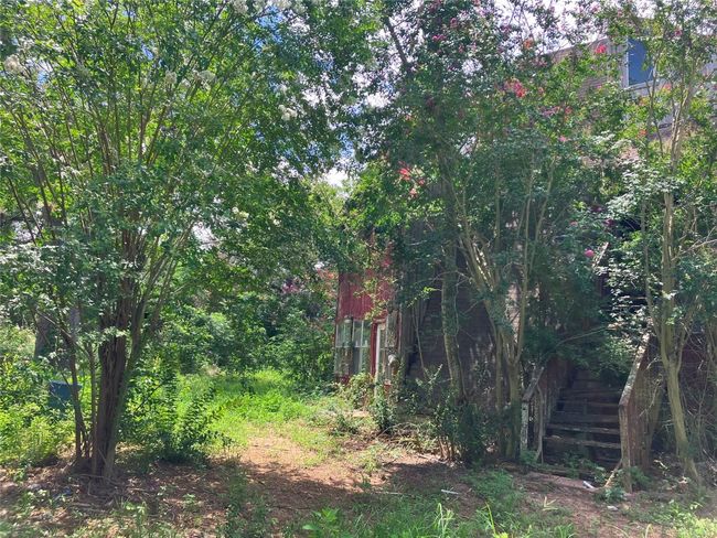 A-Frame House in need of repair or removal. Property is secluded with mature native trees. | Image 17