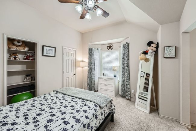 Bedroom with light carpet, vaulted ceiling, and ceiling fan | Image 22