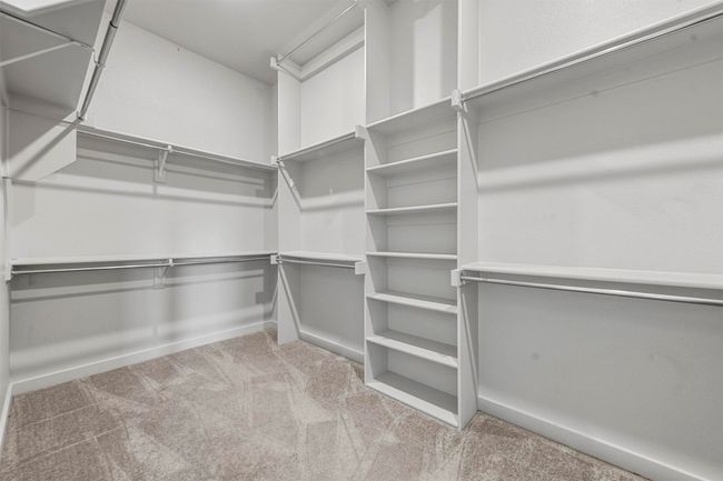 Spacious closet with light colored carpet | Image 28