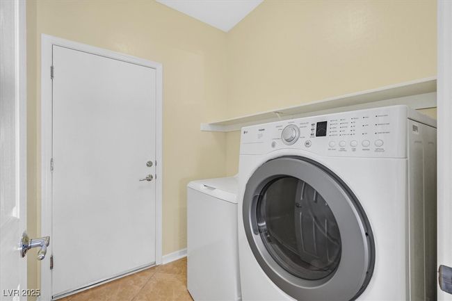 Laundry room, light tile patterned floors, and separate washer and dryer | Image 25