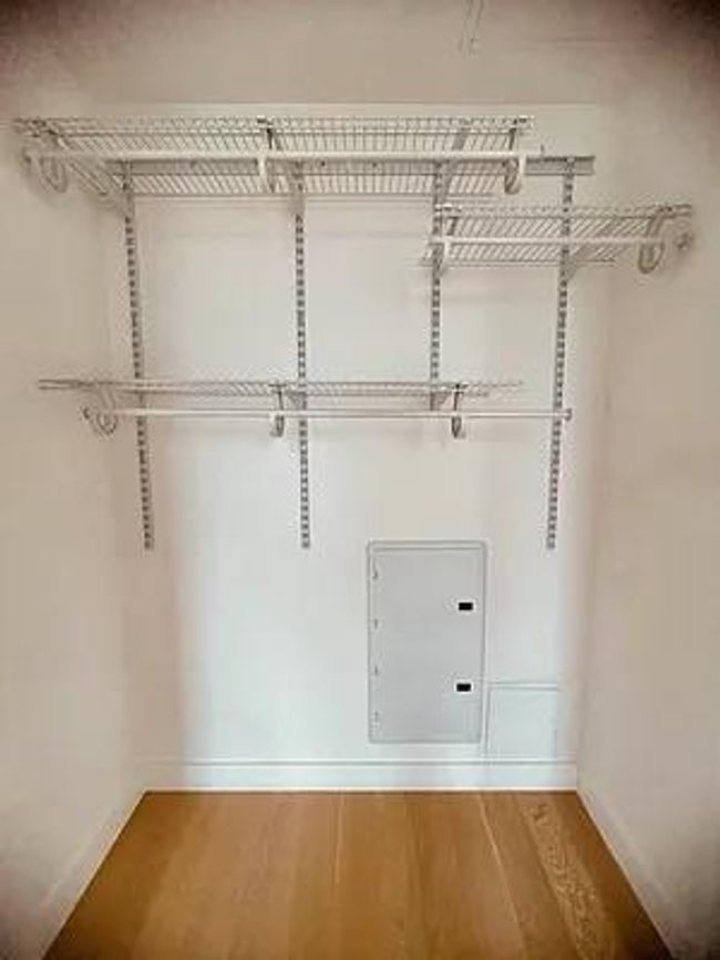 Walk in closet with wood finished floors | Image 7