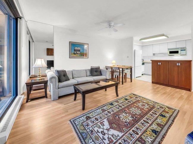 Living area featuring ceiling fan, baseboard heating, and light wood-type flooring | Image 6