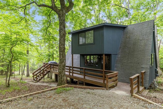 Back of house featuring a deck and stairs | Image 47