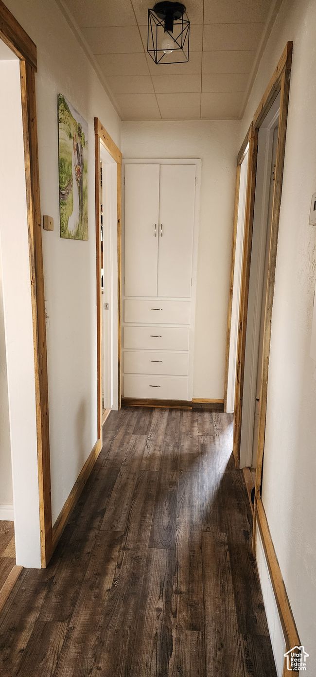 Corridor featuring baseboards and dark wood-style flooring | Image 8