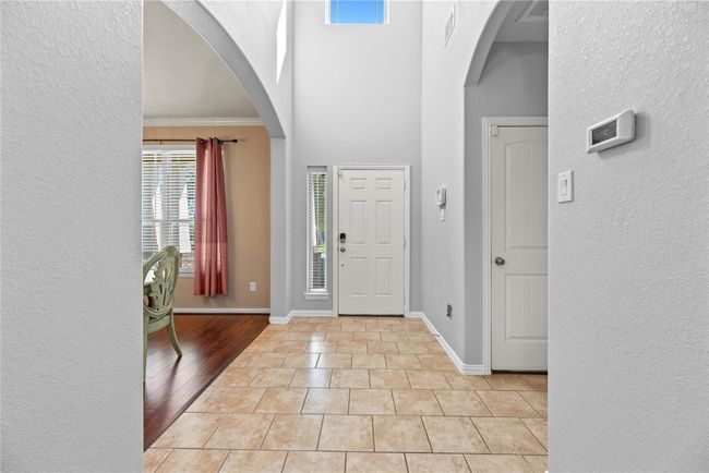 Entering the home, guests are met with durable tile flooring, which is accented with white baseboards. | Image 19