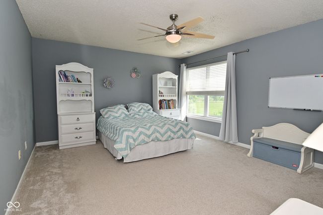 bedroom featuring carpet floors, a textured ceiling, baseboards, and ceiling fan | Image 31