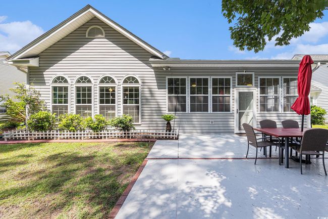 Back of property featuring a patio area, a lawn, and outdoor dining area | Image 37