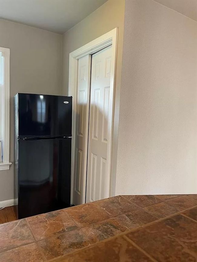 Kitchen with freestanding refrigerator | Image 6