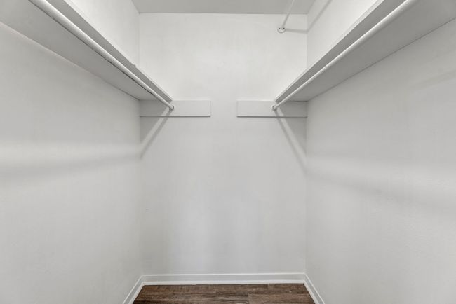 Walk in closet featuring dark wood finished floors | Image 14