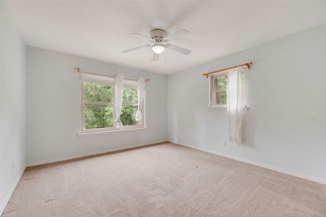 Carpeted empty room with a ceiling fan and baseboards | Image 17