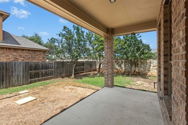 Fenced backyard featuring a patio area | Image 31