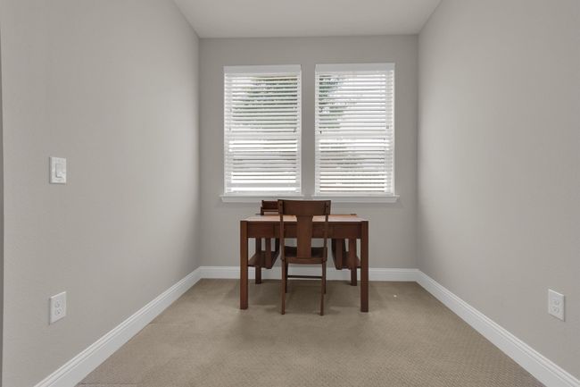 Sitting Area or Home office space located in Master Bedroom with light colored carpet and baseboards | Image 18