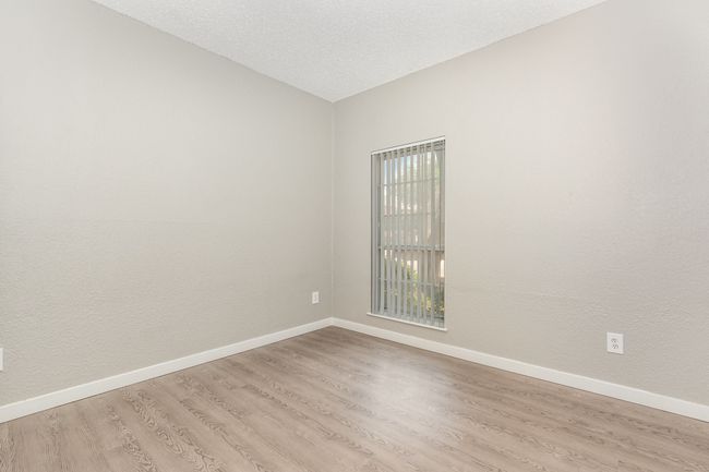 Empty room with light wood-style flooring, baseboards, and vaulted ceiling | Image 20