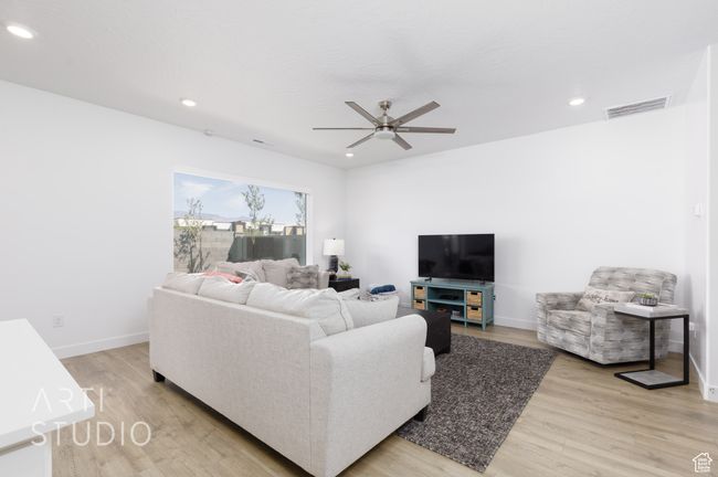 Living room featuring recessed lighting, visible vents, ceiling fan, and light wood-style flooring | Image 10