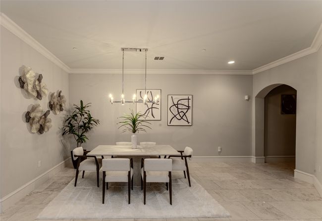 Dining space featuring arched walkways, crown molding, a chandelier, and recessed lighting | Image 18