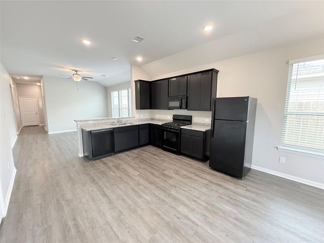 14501 SUGAR PINES DR - Kitchen with all black appliances, refrigerator included | Image 15