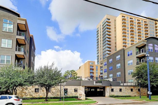 Take note of the expansive pool terrace situated above the controlled access, gated residents parking garage. | Image 22