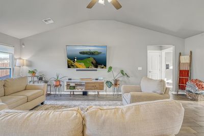 Living room with vaulted ceiling, light hardwood / wood-style flooring, and ceiling fan | Image 2