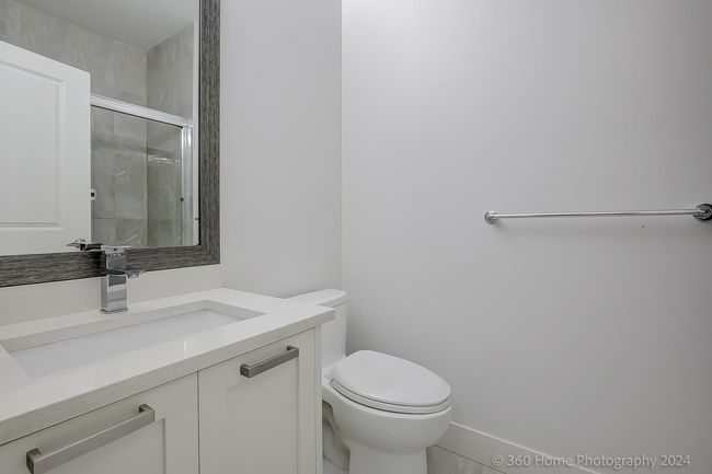 Full bath featuring a shower with shower door and vanity | Image 15