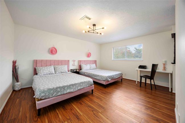 Another spacious primary bedroom on the second floor featuring two walk-in closets, a separate bathroom with a shower/tub combo, and dual vanities with two sinks. | Image 41