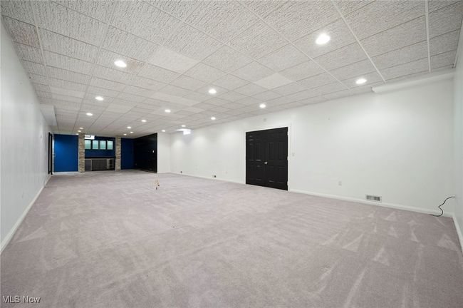 Basement featuring carpet, recessed lighting, a drop ceiling, wet bar and shower | Image 38