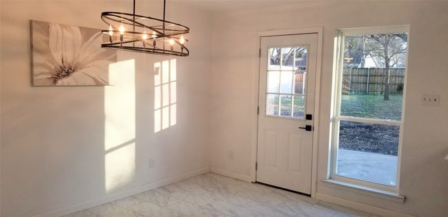 Doorway with baseboards, light marble finish floors, and a chandelier | Image 18