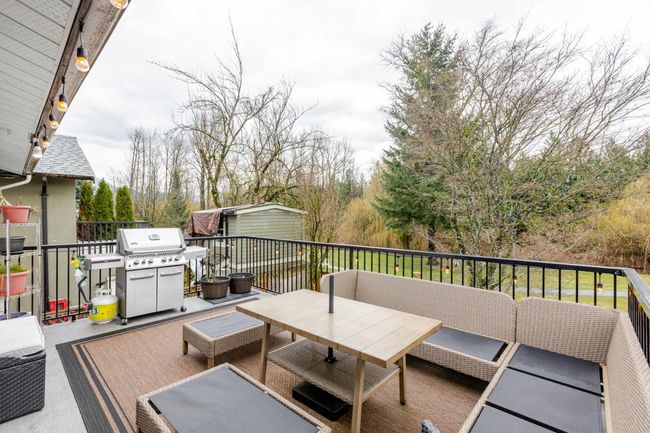 View of patio with a grill and a storage unit | Image 18